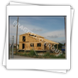 House with walls from preassembled panels (framework) with polystyrene on the exterior side and on the interior side with wood and plaster- view durring the assembly